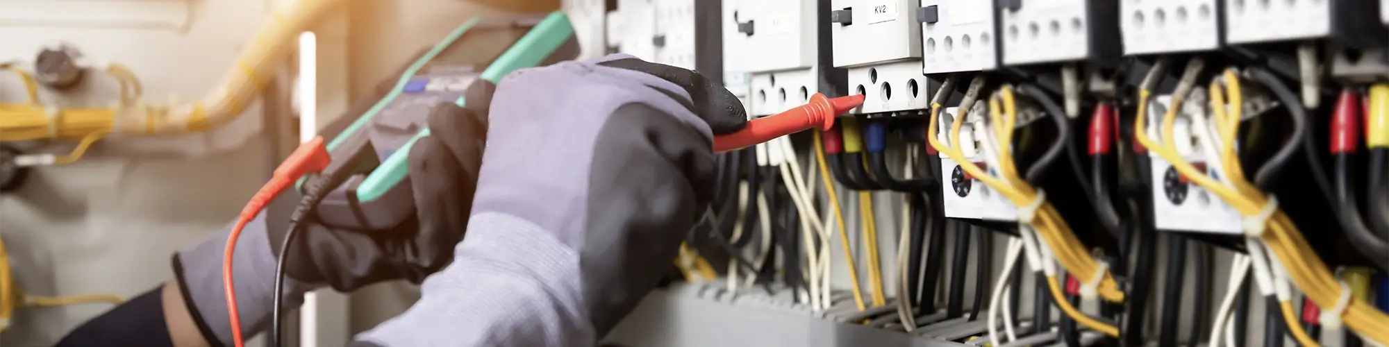 Electrician engineer tests electrical installations and wires on relay protection system. Adjustment of scheme of automation and control of electrical equipment.