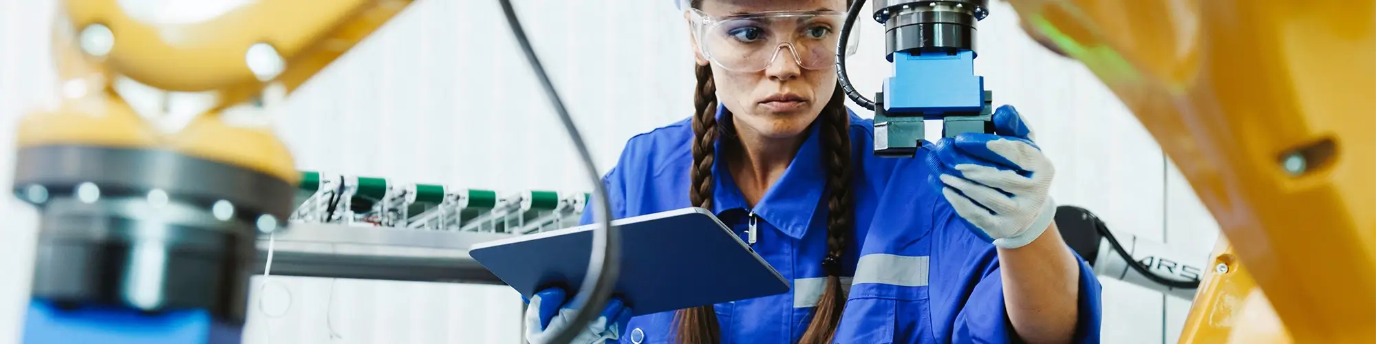 female automation machine engineer student study and inspection control robot arm machine in university or factory workshop. AI robot technology are new innovation trend for manufacturing in industry